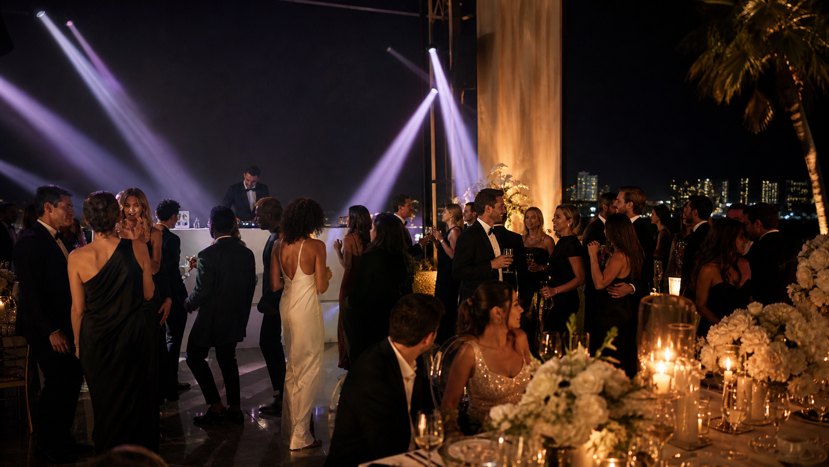 Guests dancing at an outdoor night reception with beams of light.
